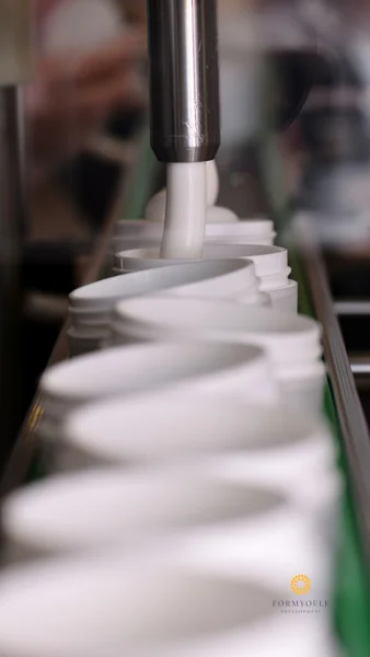 filling up bottles of face cream
