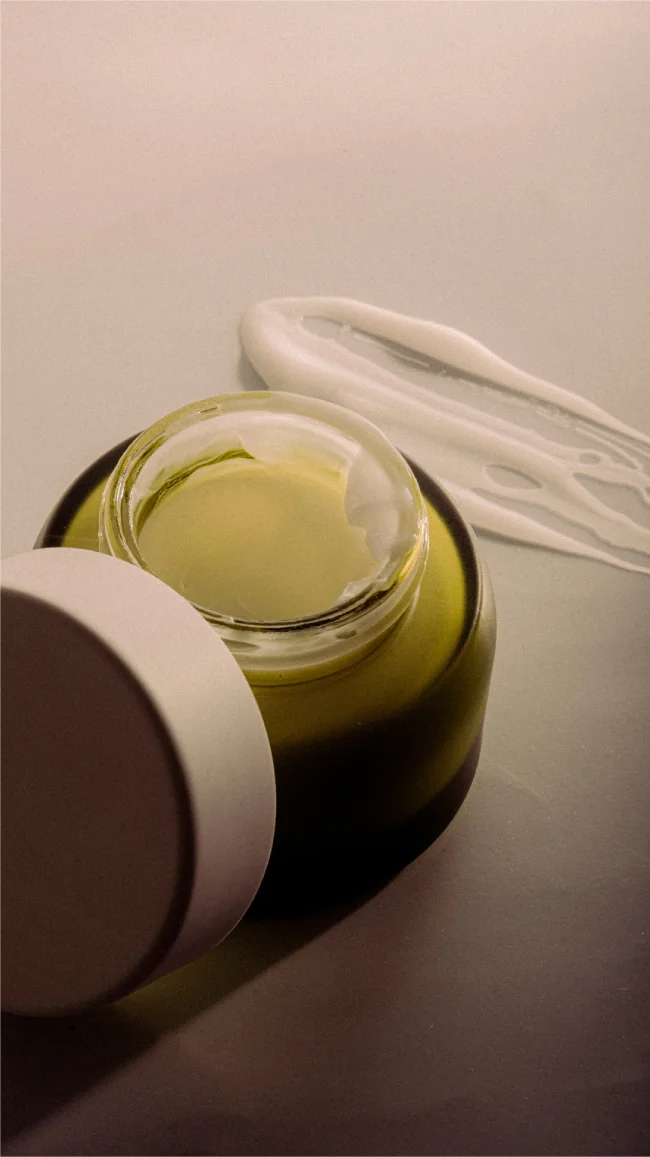 a jar of cream and a white liquid